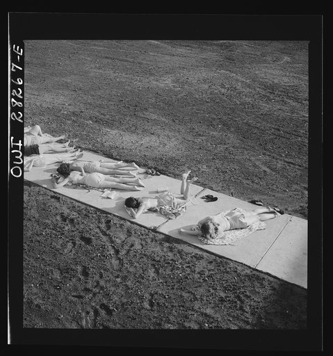 Untitled photo, possibly related to: Arlington Farms, war duration residence halls. Sunbathers on the sidewalk in the back of Idaho Hall at Arlington Farms