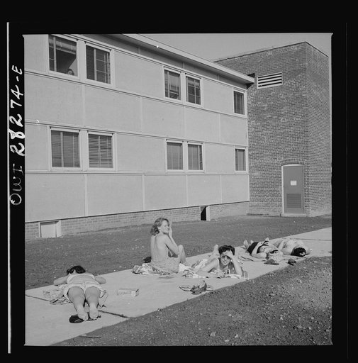 Arlington Farms, war duration residence halls. Sunbathers on the sidewalk in the back of Idaho Hall