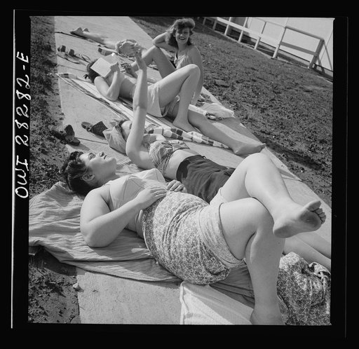 Arlington Farms, war duration residence halls. Sunbathers on the sidewalk in the back of Idaho Hall at Arlington Farms