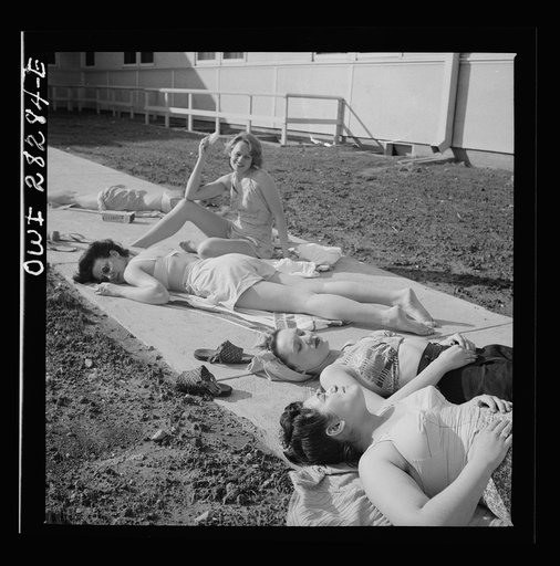 Arlington Farms, war duration residence halls. Sunbathers on the sidewalk in the back of Idaho Hall at Arlington Farms