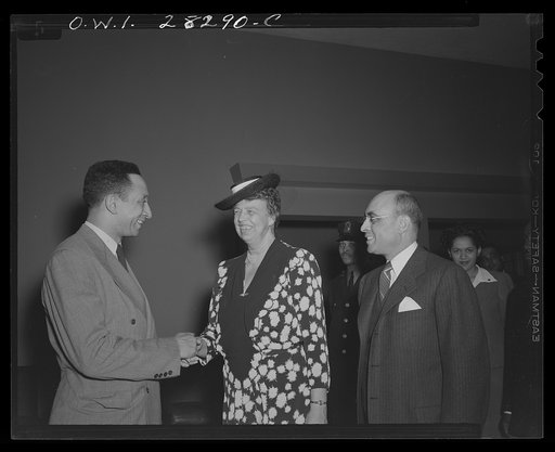First lady inspects war workers homes. On an inspection tour of federal dormitories for war workers in Washington, D.C. on May 18, Mrs. Eleanor Roosevelt visited four projects recently erected for Negroes. Shown greeting the First Lady at George Washington Carver Hall, residential hotel for Negro me