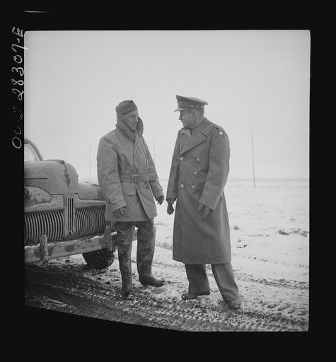 Somewhere in the Persian corridor. A United States Army truck convoy carrying supplies for the aid of Russia. From the left: Captain J. Priggee of Newark, New Jersey, the convoy leader, and Colonel Don Shingler, Commander United States Army truck fleets of Iran and Iraq. Colonel Shingler is wearing 