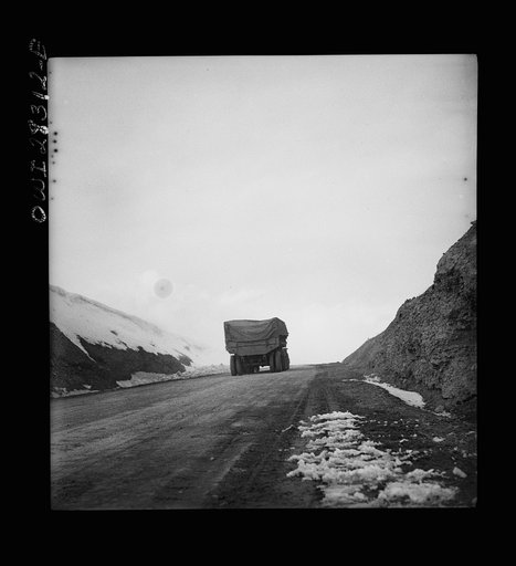 Somewhere on the Persian corridor. A United States Army truck convoy carrying supplies for the aid of Russia on a mountain road