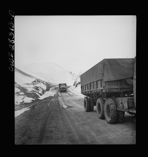 Somewhere on the Persian corridor. A United States Army truck convoy carrying supplies for the aid of Russia on a mountain road