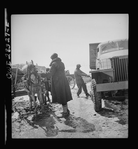 Somewhere in the Persian corridor. A United States Army truck convoy carrying supplies for the aid of Russia. Tightening the loads to the carriers before entering a dangerous, snowbound mountain pass