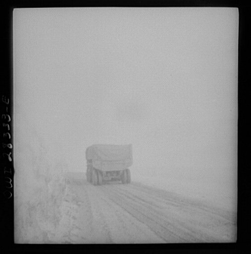 Somewhere in the Persian corridor. A United States Army truck convoy carrying supplies for the aid of Russia. This truck is heading right to the clouds as it passes through a risky mountain pass
