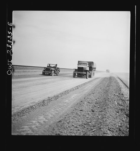 Somewhere in the Persian corridor. A United States Army truck convoy carrying supplies for the aid of Russia. The convoy leader in the jeep checking trucks as they start the trip
