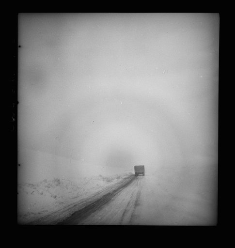 Somewhere in the Persian corridor. A United States Army truck convoy carrying supplies for Russia going through a pass over the snowbound mountain top