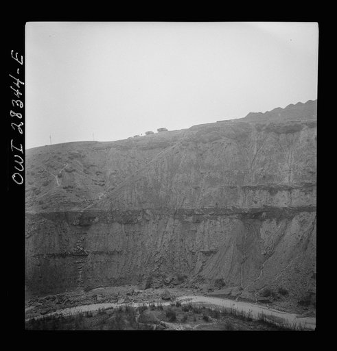 Somewhere in the Persian corridor. A United States Army truck convoy carrying supplies for Russia moving on the edge of a rocky mountain