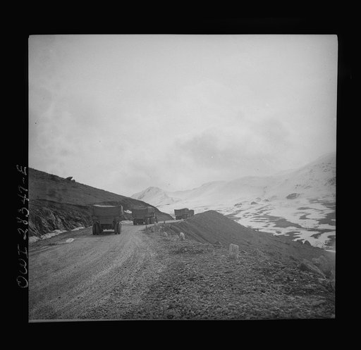 Somewhere in the Persian corridor. A United States Army truck convoy carrying supplies for Russia climbing a mountain road