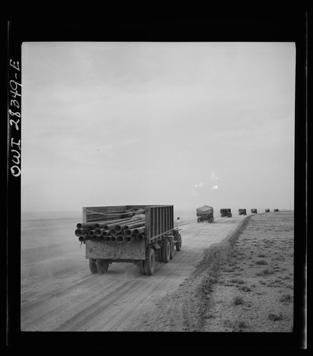 Somewhere in the Persian corridor. A United States Army truck convoy carrying supplies for Russia moving on a desert road