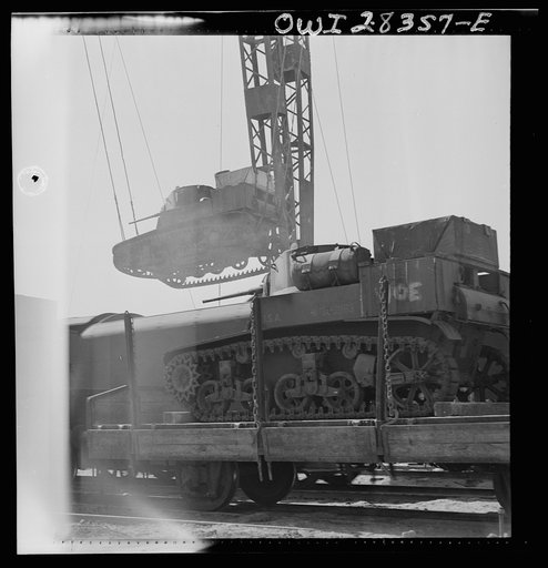 An American tank being loaded onto a railroad car enroute to Russia in the Middle East