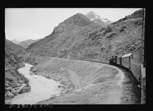 Mountainous route of trains carrying supplies to Russia. An American engine with an American crew is going along a gorge through the ever-winding route somewhere in Iran