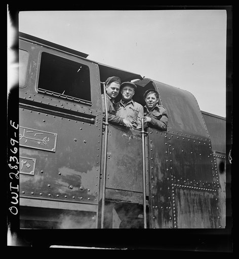 American, Russian and English engineers in the cab of an engine. Each of them has done his part in hurrying supplies enroute to Russia along a railroad in Iran