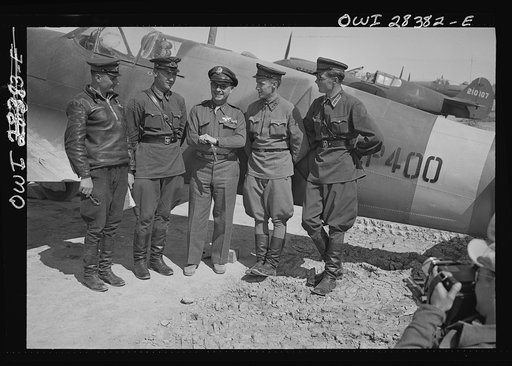 Somewhere in Iran. Major General Lewis Brererton in the center, the Commander of the United States Army force in the Middle East, with a group of Russian officers standing before an American warplane delivered to the Russians. A United States warplane is being tested in the background and bears the 