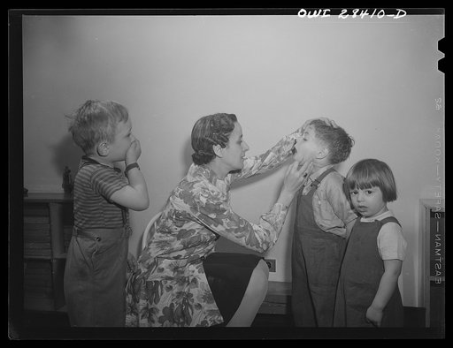 Buffalo, New York. Lakeview nursery school for children of working mothers, operated by the Board of Education at the tuition fee of three dollars weekly. Teacher examining child's throat