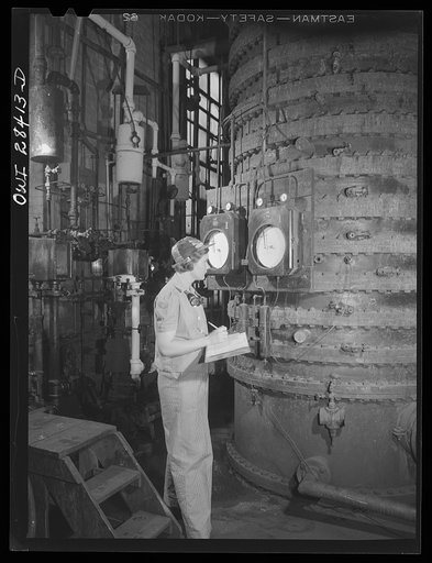 Untitled photo, possibly related to: Niagara Falls, New York. Nan Hannegan, a nineteen year old chemical operator at the Niacet chemical company earning thirty-nine dollars a week, taking readings from dials and thermometers