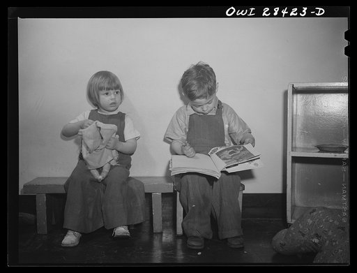 Buffalo, New York. Lakeview nursery school for children of working mothers, operated by the Board of Education at the tuition fee of three dollars weekly. Brother and sister amusing themselves with a doll and book