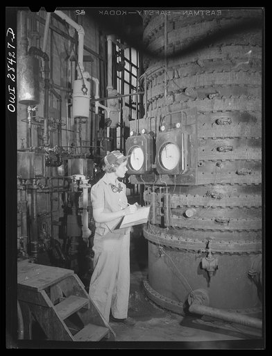 Niagara Falls, New York. Nan Hannegan, a nineteen year old chemical operator at the Niacet chemical company earning thirty-nine dollars a week, taking readings from dials and thermometers