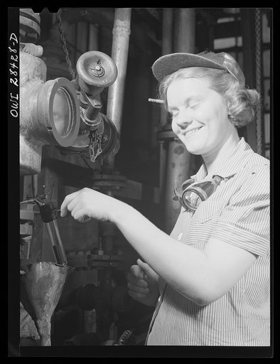 Untitled photo, possibly related to: Niagara Falls, New York. Nan Hannegan a nineteen year old chemical operator at the Niacet chemical company, earning thirty-nine dollars a week, taking readings from dials and thermometers