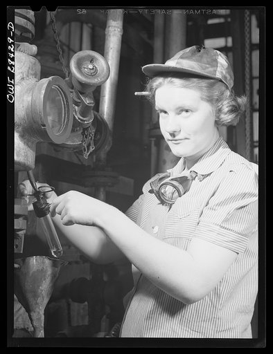 Untitled photo, possibly related to: Niagara Falls, New York. Nan Hannegan a nineteen year old chemical operator at the Niacet chemical company, earning thirty-nine dollars a week, taking readings from dials and thermometers