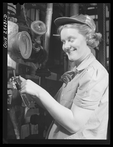 Untitled photo, possibly related to: Niagara Falls, New York. Nan Hannegan a nineteen year old chemical operator at the Niacet chemical company, earning thirty-nine dollars a week, taking readings from dials and thermometers