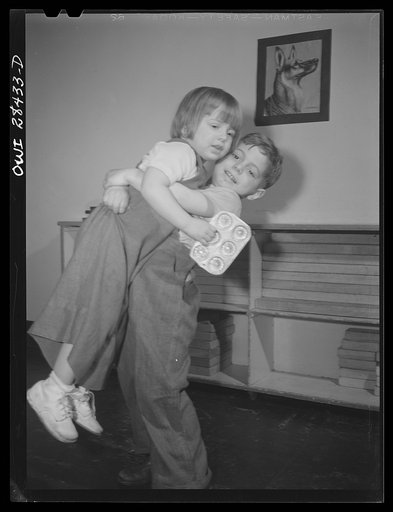 Untitled photo, possibly related to: Buffalo, New York. Lakeview nursery school for children of working mothers, operated by the Board of Education at the tuition fee of three dollars weekly. Brother and sister amusing themselves with a doll and book