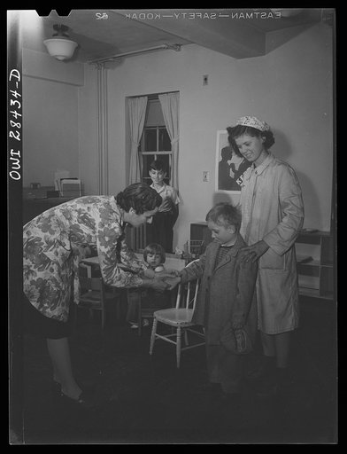 Buffalo, New York. Lakeview nursery school for children of working mothers, operated by the Board of Education at the tuition fee of three dollars weekly. A child showing his new wristwatch to the teacher
