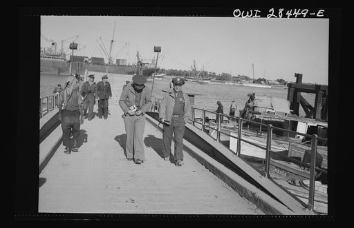 Major General Lewis Brererton inspecting port facilities handling ships bringing supplies for the aid of Russia somewhere in the Middle East
