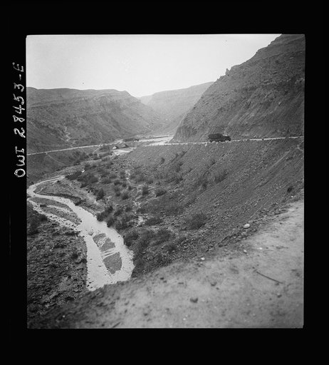 Somewhere in the Persian corridor. A United States Army truck convoy carrying supplies for the aid of Russia winding its way around a gorge over a mountain pass