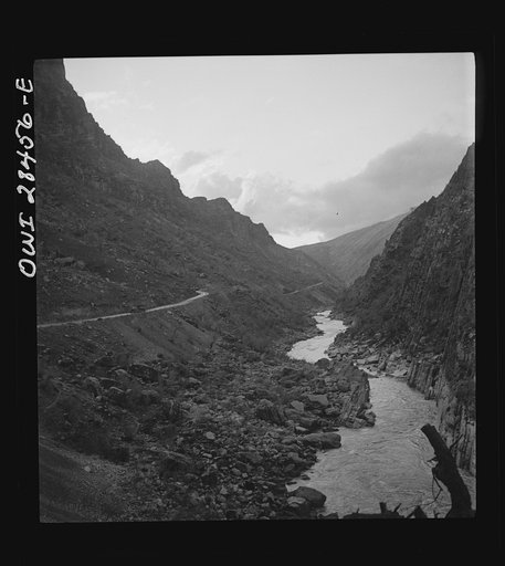 Somewhere in the Persian corridor. A United States Army truck convoy carrying supplies for Russia on a mountain road which winds along the mountainside with a sheer drop into the gorge on one side