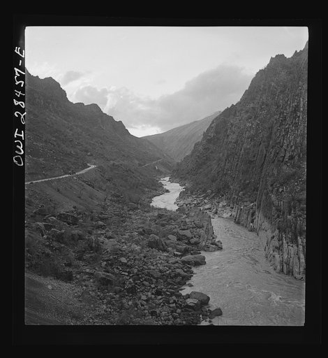 Somewhere in the Persian corridor. A United States Army truck convoy carrying supplies for Russia on a mountain road which winds along the mountainside with a sheer drop into the gorge on one side