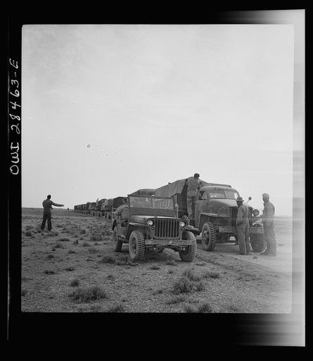 Somewhere in the Persian corridor. A United States Army truck convoy carrying supplies for Russia making a rest stop in the desert
