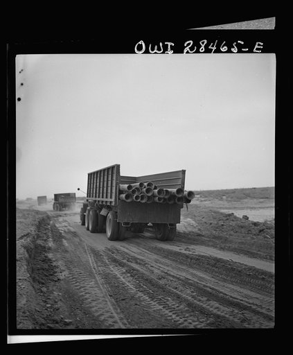 Somewhere in the Persian corridor. A United States Army truck convoy carrying supplies for Russia moving along on a sandy desert road