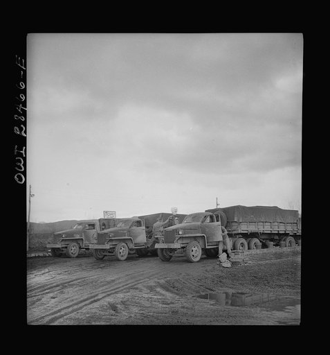 Somewhere in the Persian corridor. A United States Army truck convoy carrying supplies for Russia at a petrol point