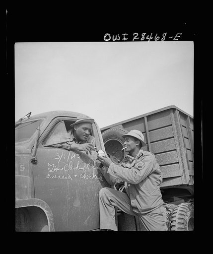 Somewhere in the Persian corridor. A United States Army truck convoy carrying supplies for Russia stopping to check trucks and for the drivers to have a smoke on the desert