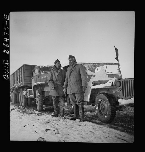 Somewhere in the Persian corridor. A United States Army truck convoy carrying supplies for Russia. Captain J. Priggee, Newark, New Jersey, and Lieutenant. S. McClure, Nashville, Tennessee, leaders of the truck convoy, are about to start out at dawn. The Captain of the convoy rides in a jeep at the r