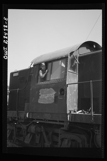 Somewhere in Iran. Major General Brererton inspecting a newly-arrived diesel engine which will be used to pull supplies to Russia. Major General Brererton is the Commading General of the United States Army forces in the Middle East