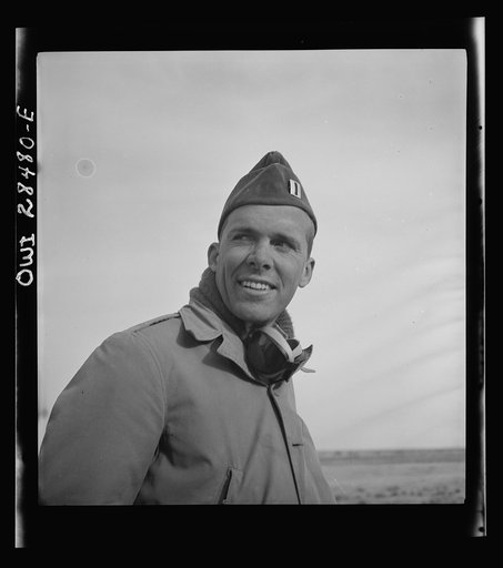 Somewhere in the Persian corridor. A United States Army truck convoy carrying supplies for Russia. Captain C.B. Cutler of Chicago, Illinois, dust-covered and wearing sand goggles. The leader of a convoy riding a jeep at the end of the line checking disabled trucks as he passes. A repair crew also mo