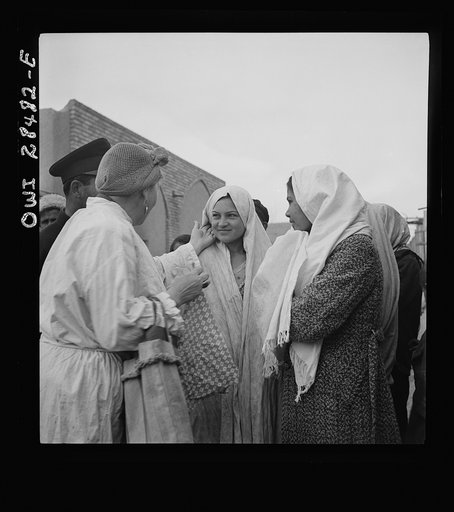 Teheran, Iran. Mrs. Louis Dreyfus, wife of the United States Minister to Iran, talking with native girls