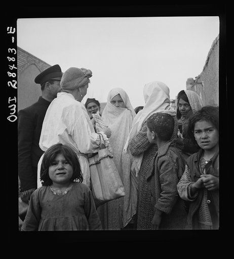 Teheran, Iran. Mrs. Louis Dreyfus, wife of the United States Minister to Iran, visiting in the poorer section of the city