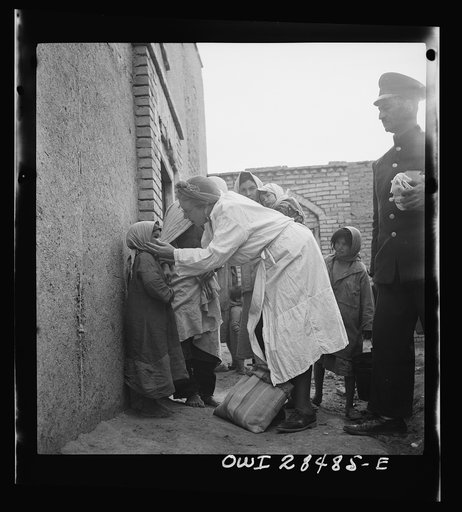 Teheran, Iran. Mrs. Louis Dreyfus, wife of the United States Minister to Iran, distributing food and medical supplies in the poorer section of the city