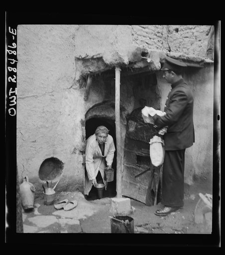 Teheran, Iran. Mrs. Louis Dreyfus, wife of the United States Minister to Iran, distributing food to natives