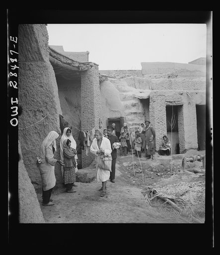 Teheran, Iran. Mrs. Louis Dreyfus, wife of the United States Minister to Iran, visiting a poor section and distributing supplies