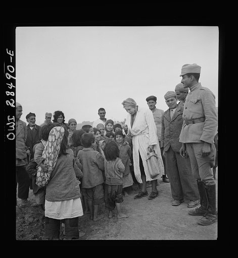 Teheran, Iran. Mrs. Louis Dreyfus, wife of the United States Minister to Iran, talking with native children