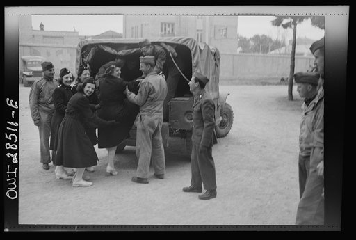 United States Army nurses being helped into the back end of a truck somewhere in Iran