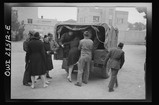 United States Army nurses being helped into the back end of a truck somewhere in Iran