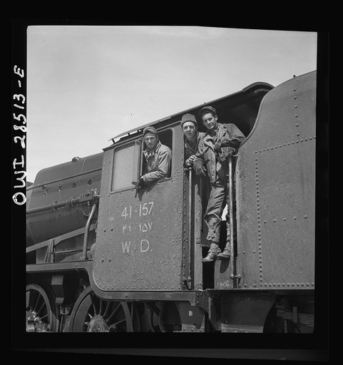 Mixed crew of American and British in the cab of an American engine somewhere in Iran