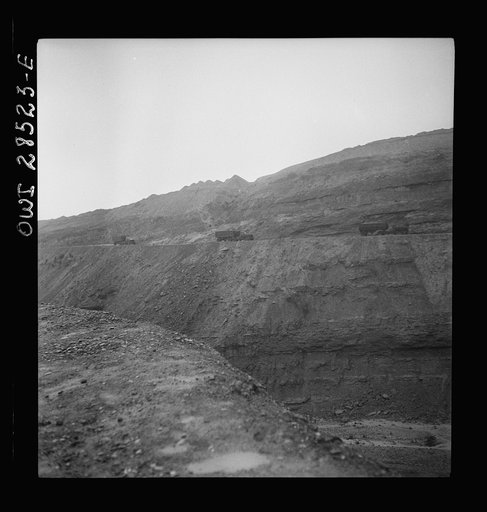 Somewhere in the Persian corridor. A United States Army truck convoy carrying supplies for Russia on a ledge of a rocky mountain