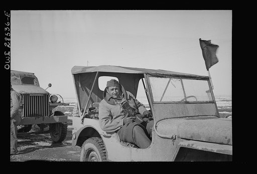 OWI (Office of War Information) photographer Nick Parrino somewhere in the Persian corridor in the Jeep in which he rode to make a photographic record of the first run by an all American United States Army convoy carrying supplies for Russia